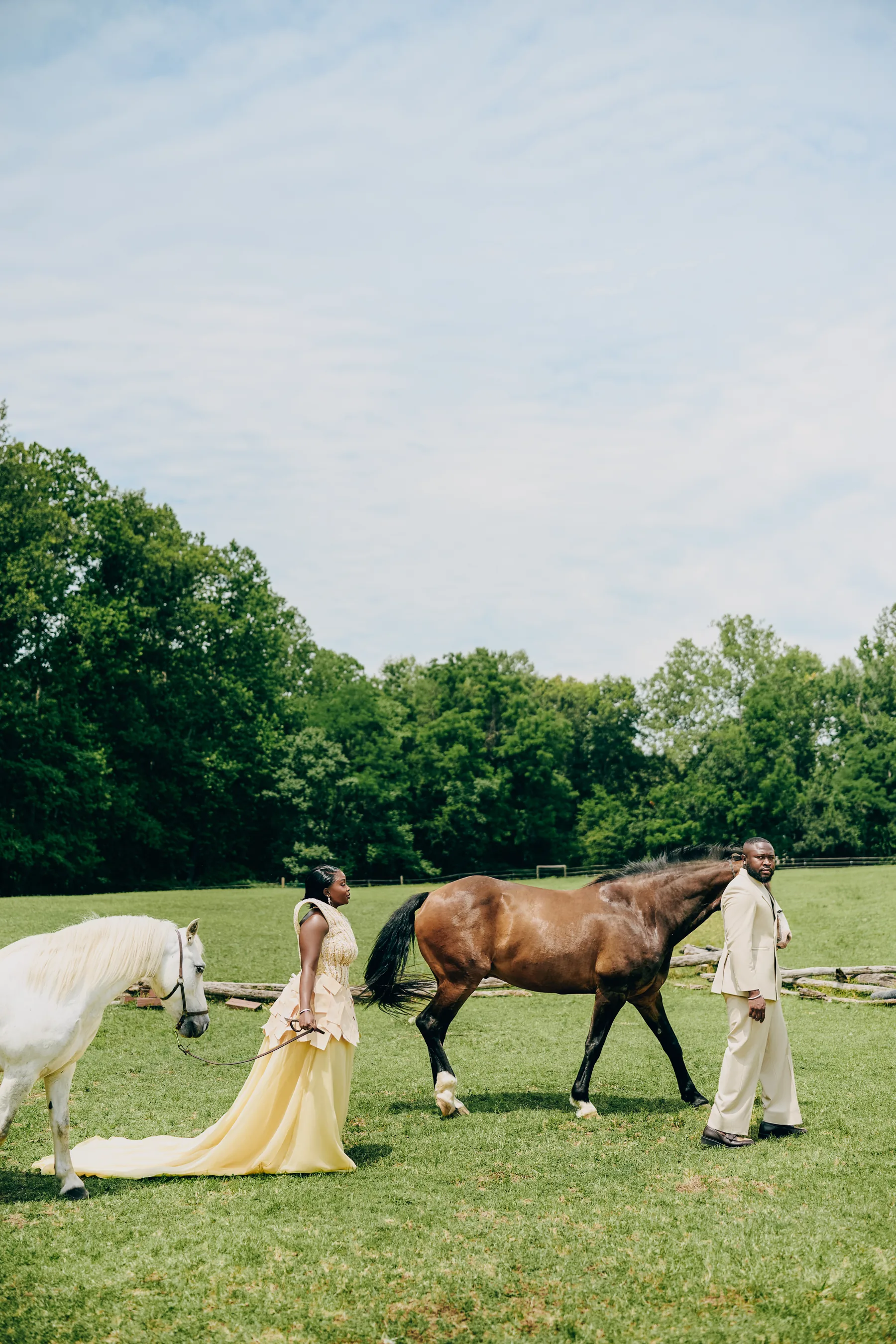 Ryan and Samanta walking horses across the pasture