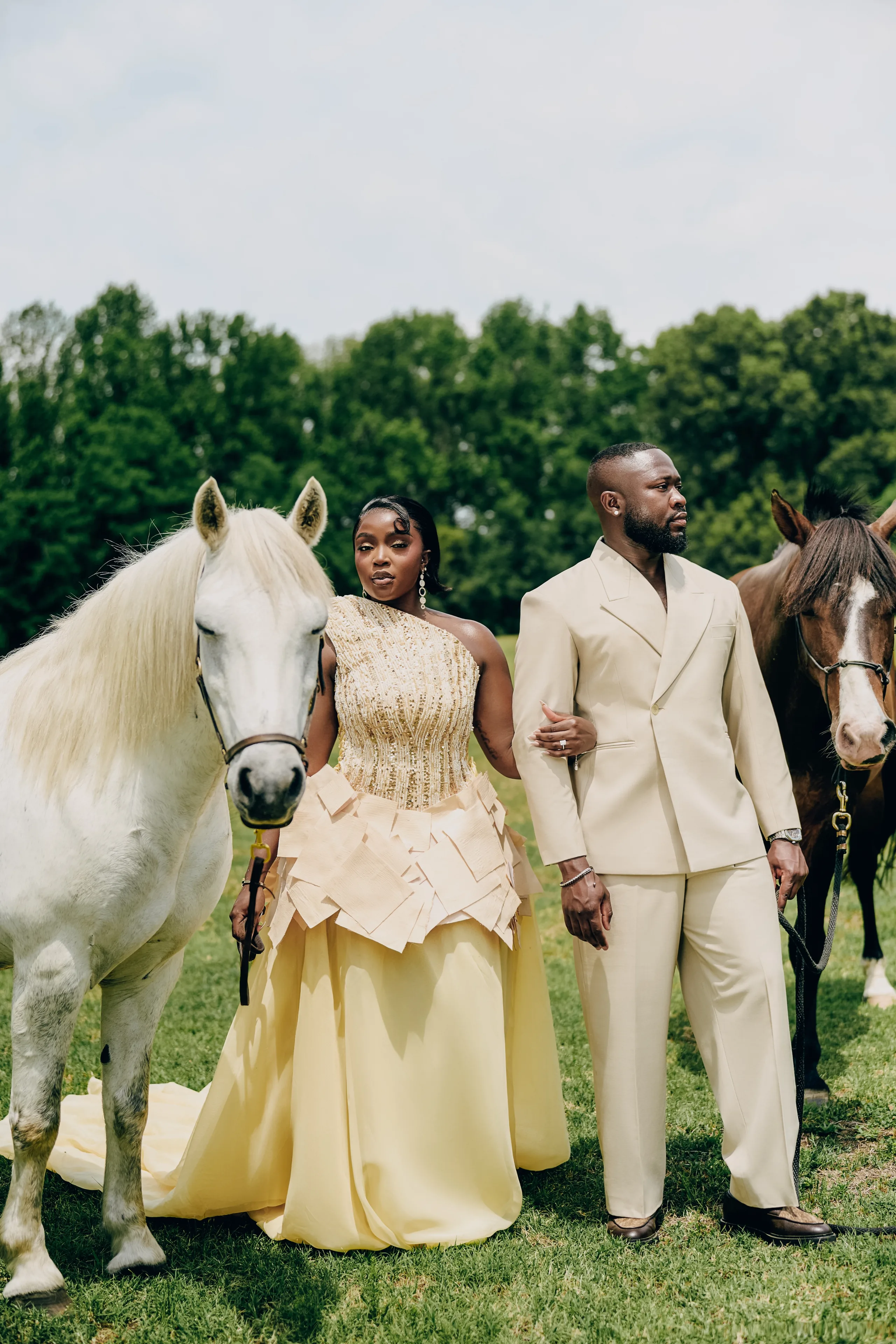 Ryan and Samanta standing back to back in a Hill Country pasture with three horses