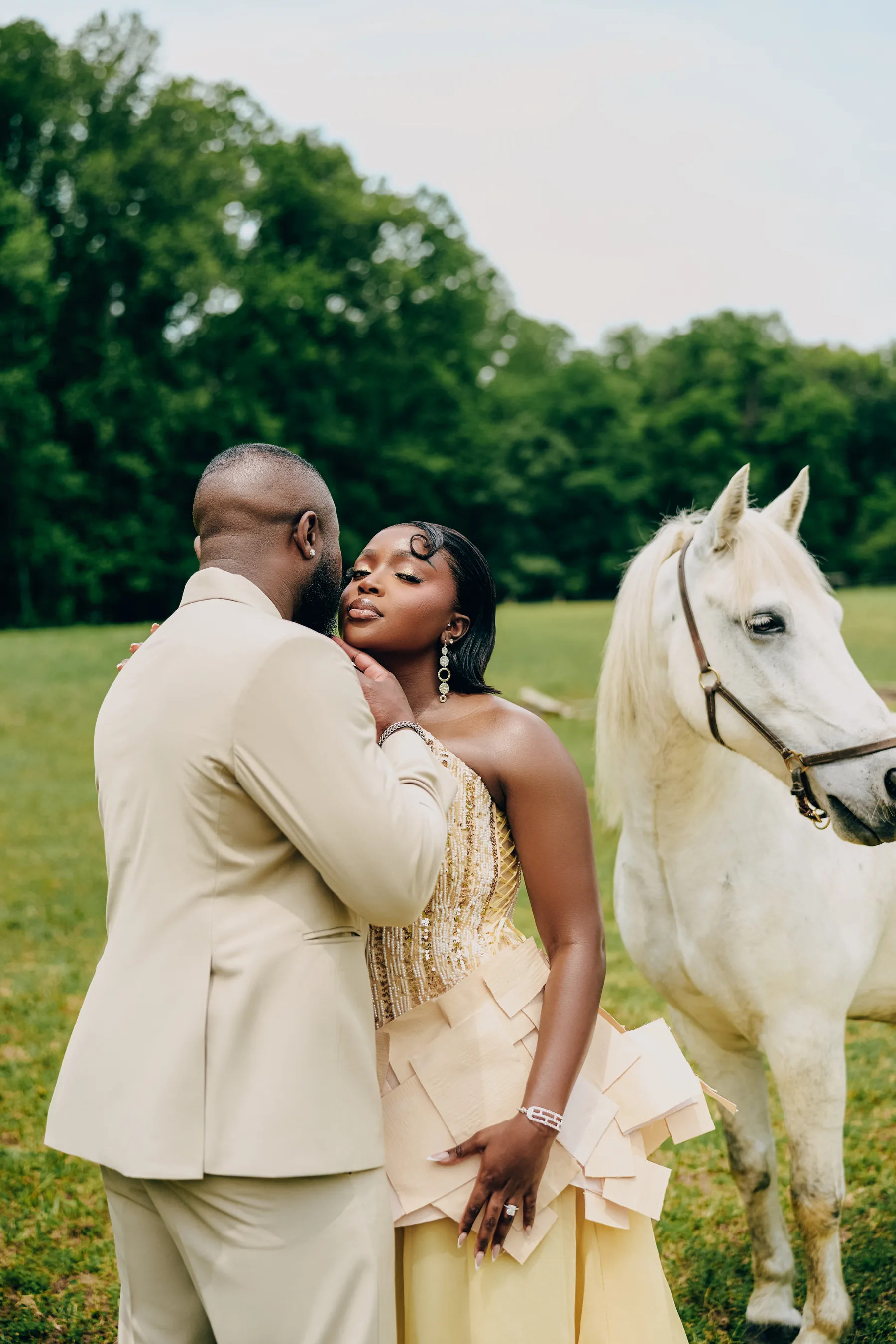 Ryan and Samanta close together beside a white horse